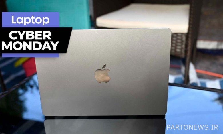 MacBook Air M2 sitting on a glass coffee table with the lid facing the camera and a Cyber Monday banner in the upper-left corner