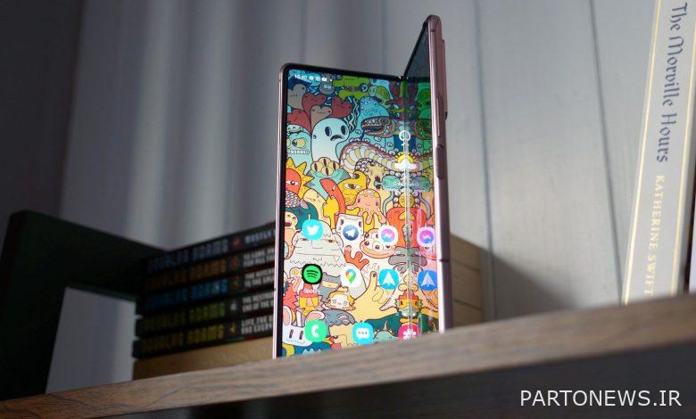 Samsung Galaxy Fold stood vertically on a shelf half open