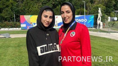 The silver medal of Italy around the neck of the Iranian woman wearing a hood