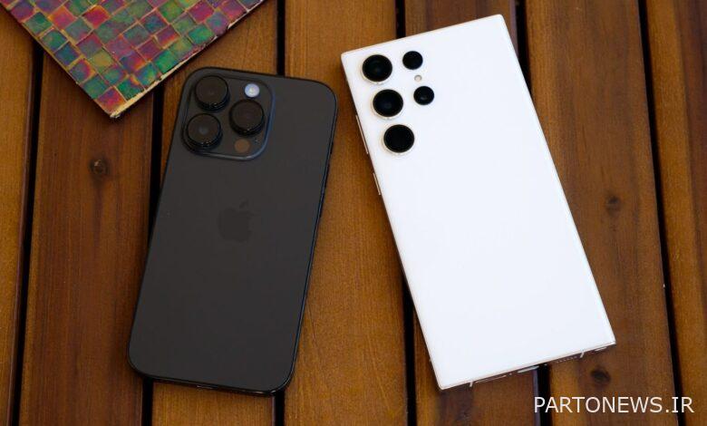 iPhone 14 Pro and Galaxy S23 Ultra screen side down on a slatted wooden side table