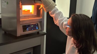 A scientist observes battery material production.
