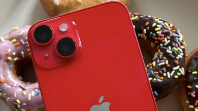 A red iPhone with donuts in the background.