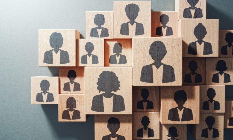 Team work and human resource management concept. Top view of various wood cubes with people icons.