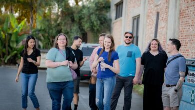 small group of young folks standing in a parking lot