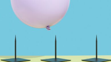 Image of a pink balloon hovering over three spikes to represent risk.