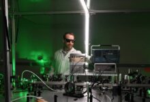 A scientist oversees a laser experiment.