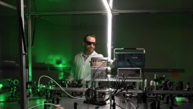 A scientist oversees a laser experiment.