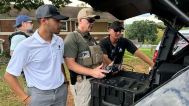Image of Asheville law enforcement and a member of Paladin's team remotely flying a drone