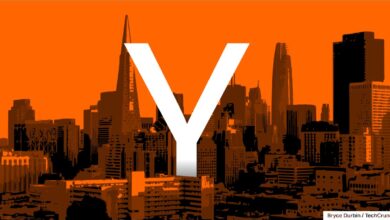 Large white "Y" overlaid on an orange-tinted skyline of San Francisco