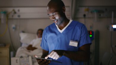 Medical practitioner using a digital tablet in a hospital ward