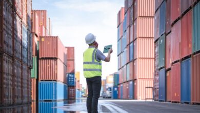 Engineer with tablet at Containers yard from Cargo freight ship for import export, used in a post about Freightify