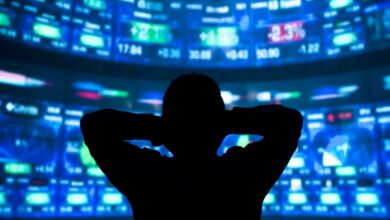 young man standing in front of the projection reflected stock market
