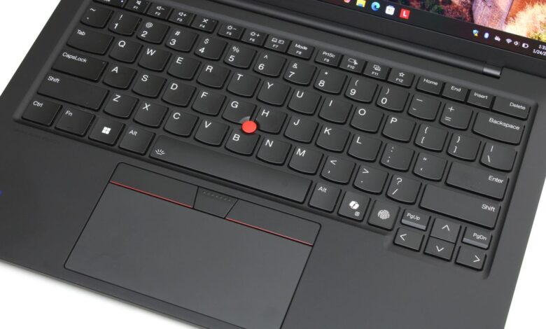 A close up of a black laptop keyboard and trackpad