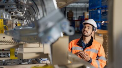 Young man industrial engineer wearing a white helmet while check the welding on the production line in the factory.