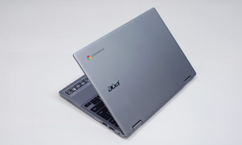 A silver laptop against a white background, its lid halfway open with the brand logo facing the camera.