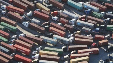 Trucks stand prepared to haul shipping containers at the Port of Los Angeles