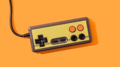 Retro video game controller on orange background.