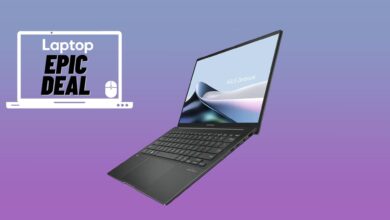 Black Asus Zenbook 14 laptop against blue and purple gradient background.