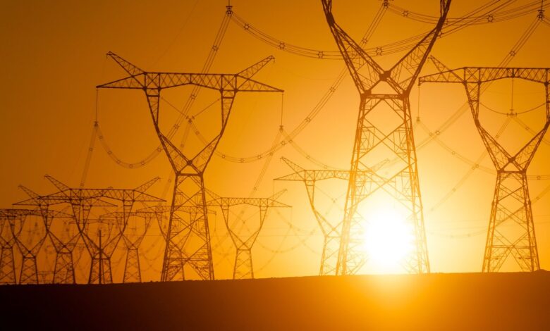 Silhouetted electricity pylon grid