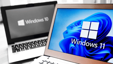 A laptop screen showing the Windows 11 logo in full color while a laptop screen in the background shows a black-and-white Windows 10 logo.