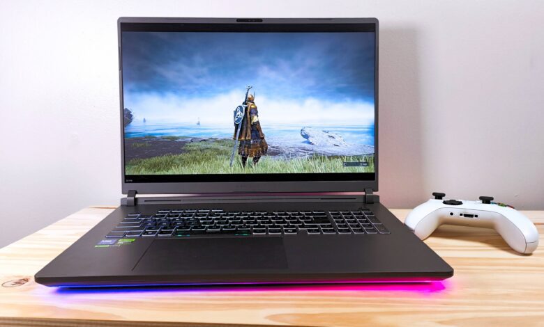 The Asus ROG Strix G18 running Elden Ring Nightreign on a wood table beside a white Xbox controller