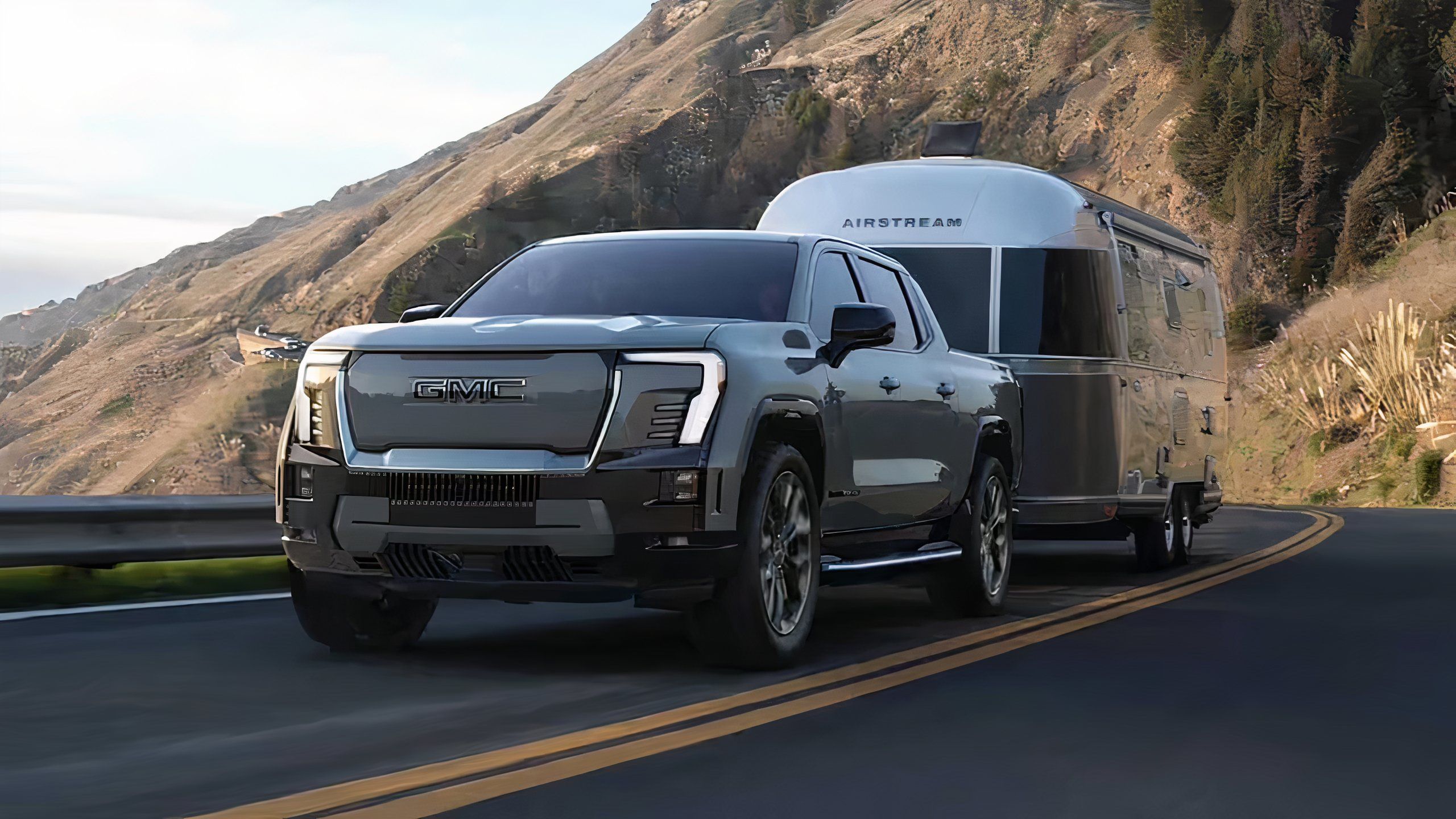 عکسی هنوز از 2024 GMC Sierra EV که یک تریلر Camper را بکشاند. 
