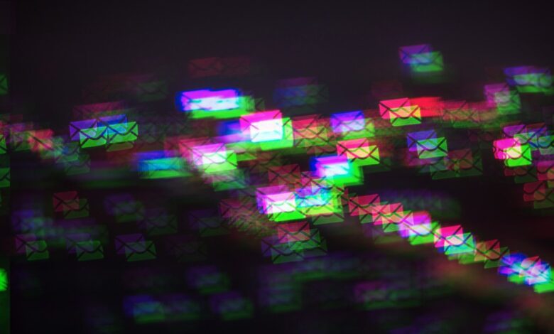 a pattern of multicolored photo-moshed envelopes flowing across on a dark background
