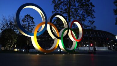 Olympic rings are seen outside the New National Stadium in Tokyo