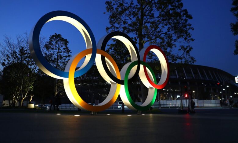 Olympic rings are seen outside the New National Stadium in Tokyo