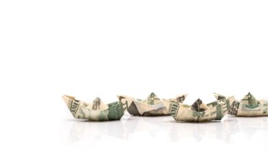 row of paper ships from dollar banknotes