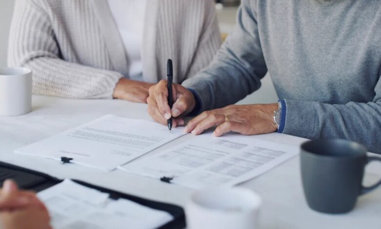 Cropped shot of a senior couple meeting with a consultant to discuss paperwork at home